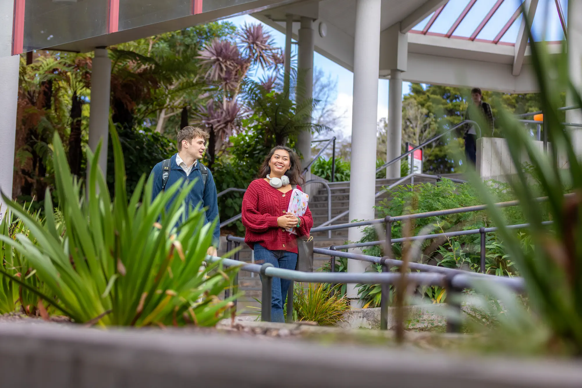 students-walking-down-stairs-by-plants