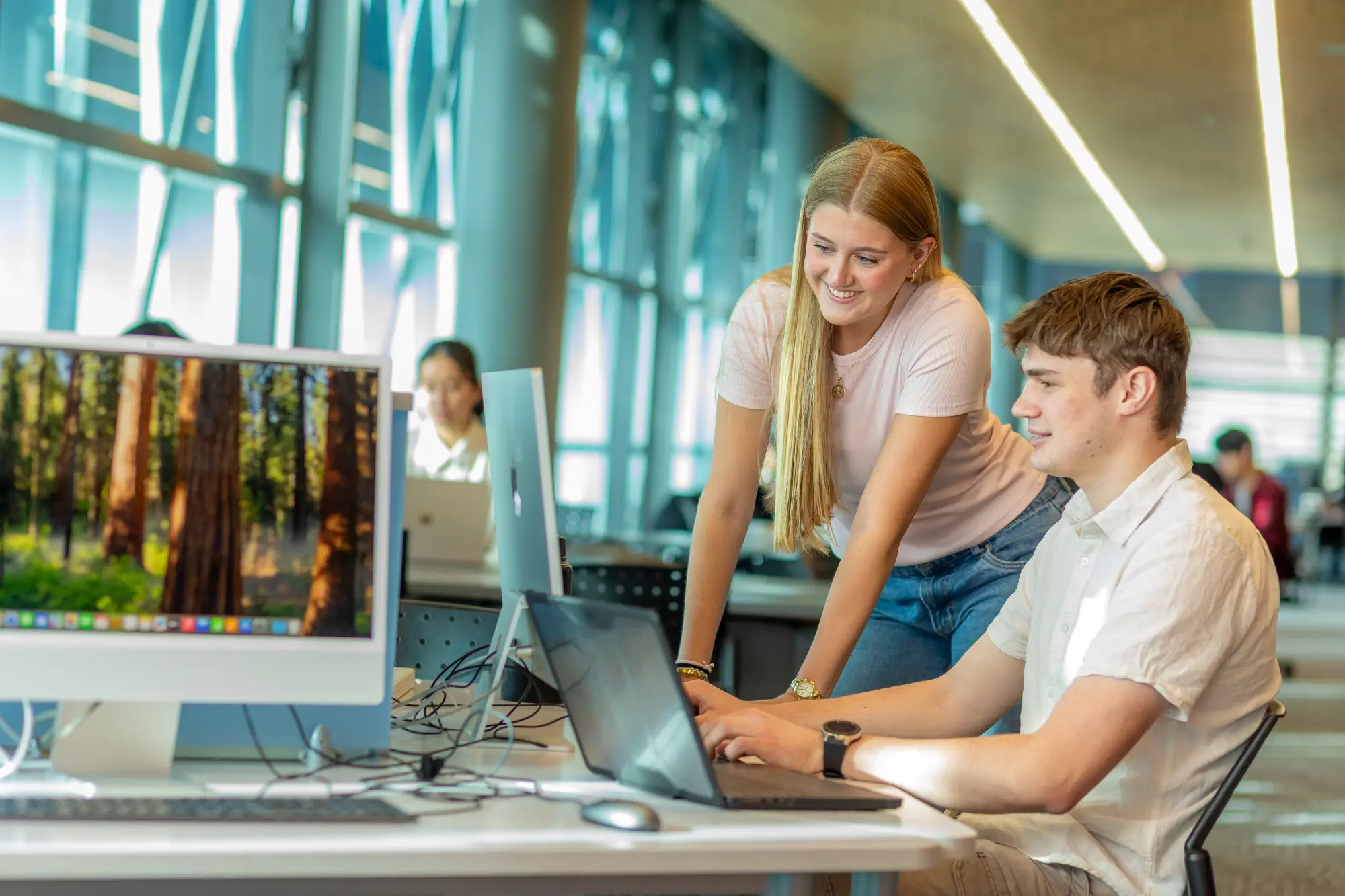 two-students-studying-on-library-computer